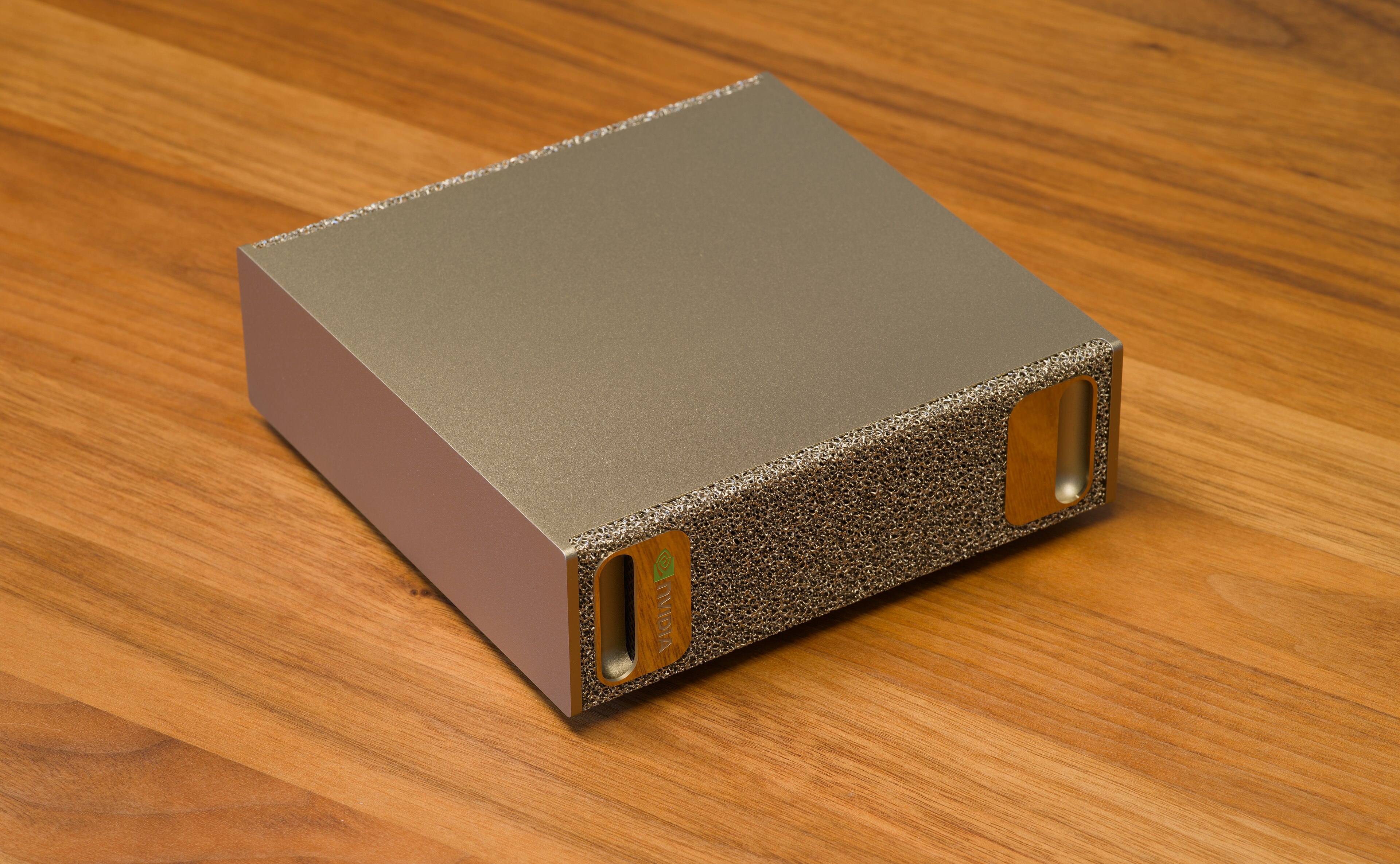 An NVIDIA DGX Spark desktop AI computer photographed on a wooden table.