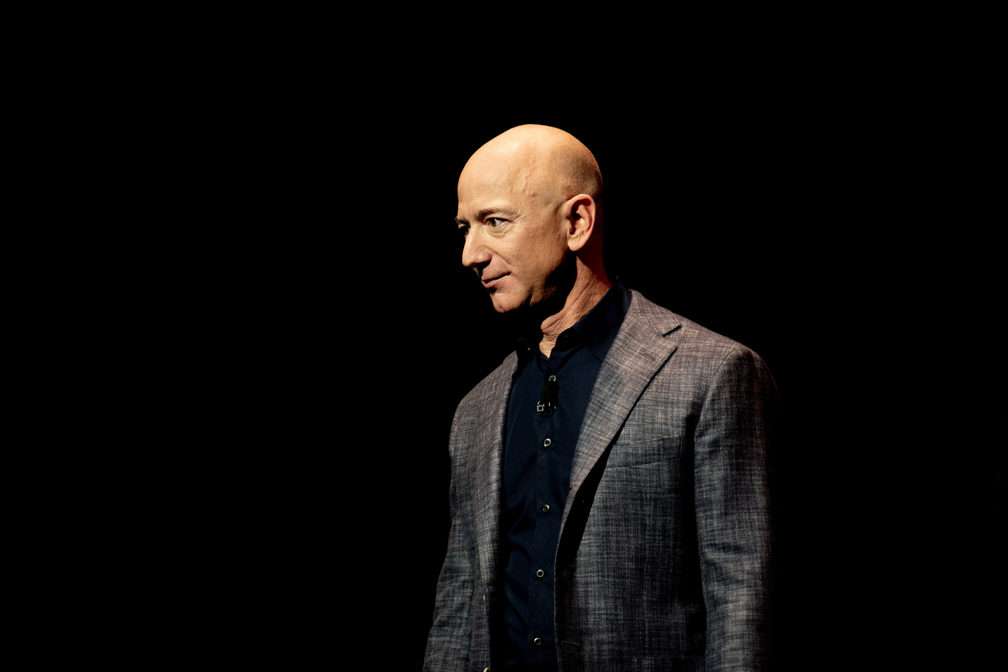 Jeff Bezos onstage against a dark backdrop at a Blue Origin event in 2019.