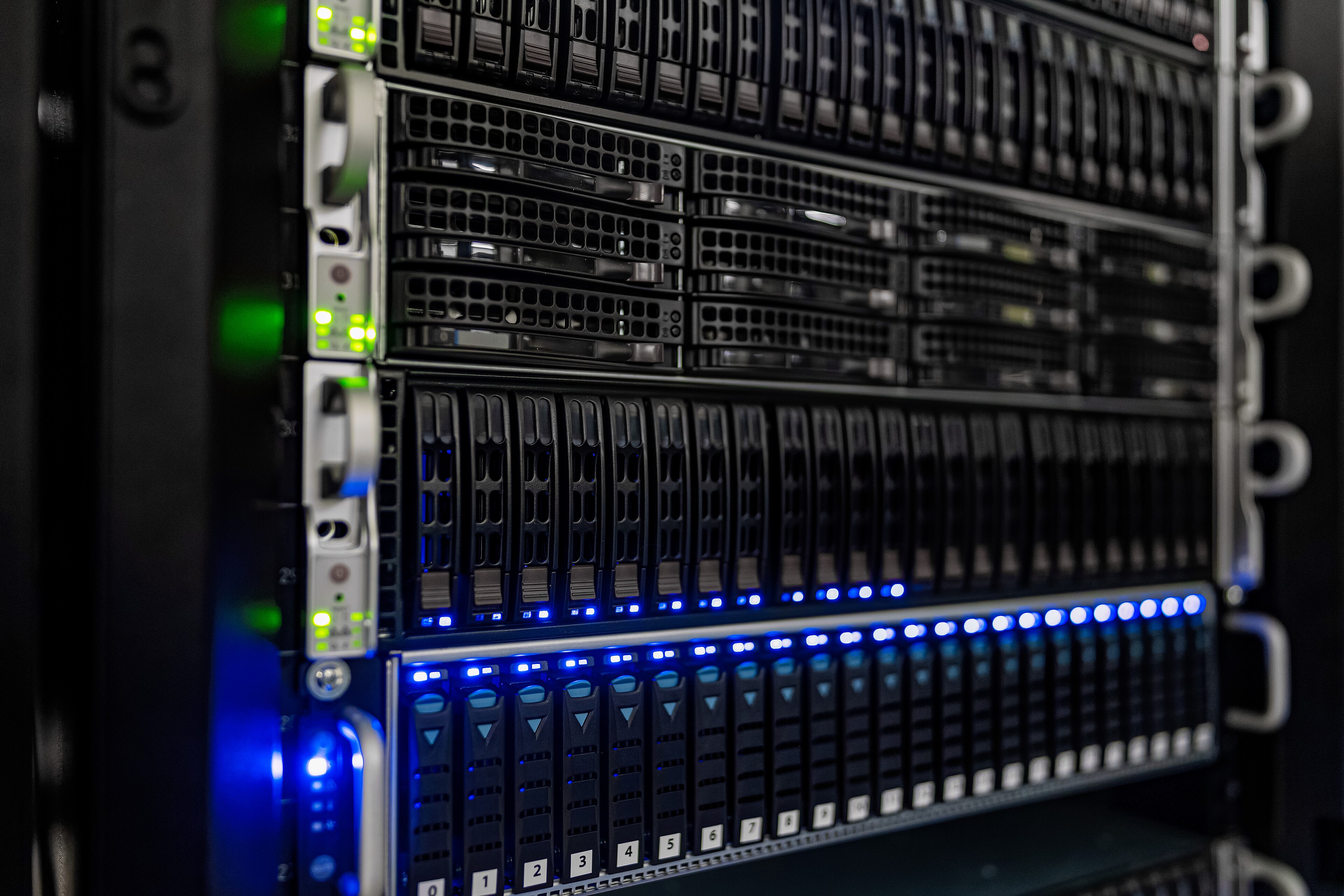 Rows of server hardware with blue and green indicator lights at NOIRLab headquarters in Tucson, Arizona.