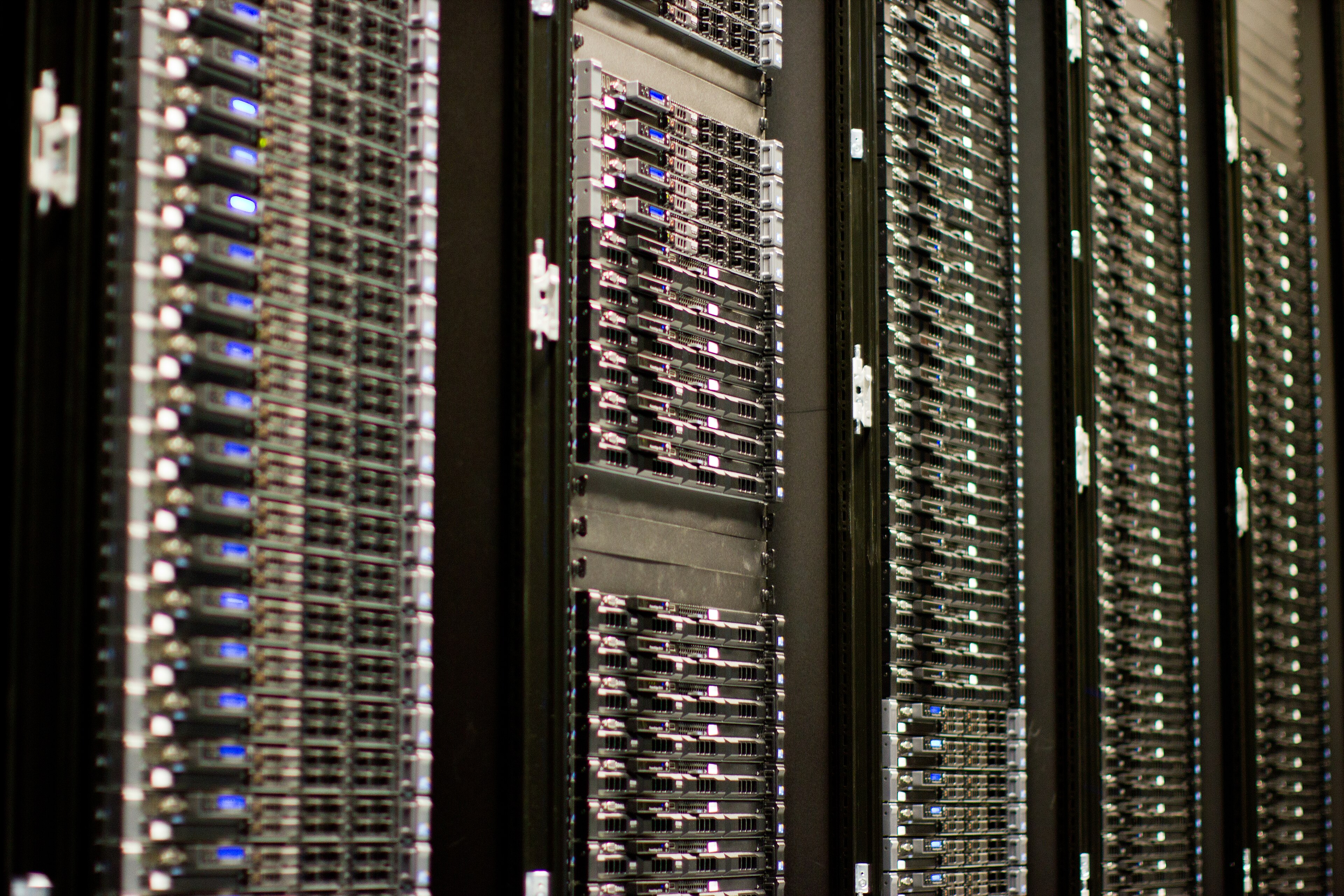 Rows of Wikimedia Foundation server racks with illuminated status indicators in an archival infrastructure photograph.